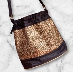 Vintage black leather crossbody bucket bag with gold metallic leopard print